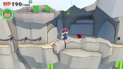 Mario standing near a Healing Heart in Spring of Rainbows of The Origami King.