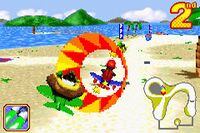 Diddy racing against K. Rool and Krunch from a beach-themed race course of Diddy Kong Pilot.