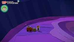 Mario standing near a rock containing a Small Bag of Confetti in Scorching Sandpaper Far East of The Origami King.