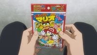 Anime character holding package of Super Mario-kun Comic Gum