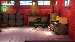 Mario standing near a 10-Coin in Toad Town of The Origami King.