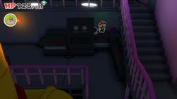 Mario standing near a Small Bag of Confetti on The Princess Peach ship of The Origami King.
