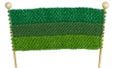 Green scarf on knitting needles
