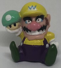 An officially licensed Mario Party 4 figurine of Wario holding a Mega Mushroom.