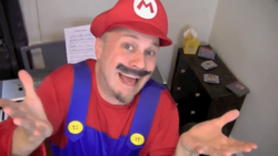 Brentalfloss dressed as Mario singing the lyric "Mamma mia, mamma mia!" in his song "Nintendohemian Rhapsody". For the List of references on the Internet page.