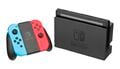 Nintendo Switch console, next to the Joy-Con attached to the grip