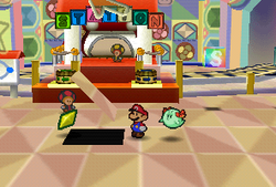 Mario finding a Star Piece in front of the red station in Shy Guy's Toy Box in Paper Mario