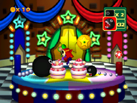 Game Guy's Sweet Surprise: Two differently sized Chain Chomps devouring their own cakes. From Mario Party 3.
