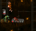 Donkey Kong jumps at a Fuel Canister above a Kritter.