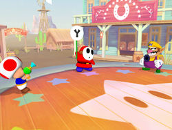 Shy Guy Showdown from Mario Party 5. It is important to note that Shy Guy is holding a fake out sign.