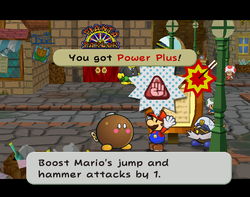 Mario getting the Power Plus badge from Lucky in Rogueport of Paper Mario: The Thousand-Year Door.