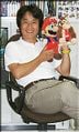 Miyamoto holding Mario and Donkey Kong plushies