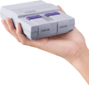 Hand holding Super NES Classic Edition as scale.