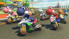 Different colored Yoshis racing on this course in Mario Kart 8 Deluxe