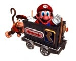 Diddy Kong pushing a Minecart with Mario riding in it as seen in the German GamePro magazine