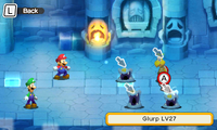 Screenshot of the double Glurp glitch, which has caused two Glurp enemies to occupy the same space in a battle in Mario & Luigi: Superstar Saga + Bowser's Minions. Note how one Glurp is selected, while the other remains darkened in front of it.