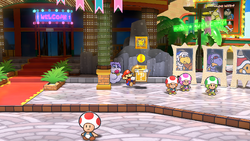Mario using his Hammer to reveal a hidden "stepping stone" ? Block in Glitzville, in the remake of the Paper Mario: The Thousand-Year Door for the Nintendo Switch.