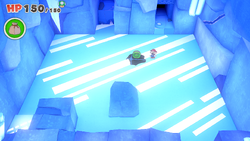Mario standing near a 100-Coin on Ice Vellumental Mountain of The Origami King.