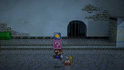 Mario revealing a hidden ? Block (containing a Pretty Lucky badge) in Rogueport Underground, in the remake of the Paper Mario: The Thousand-Year Door for the Nintendo Switch.