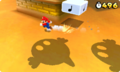Mario in a desert level being chased by Sandmaargh shadows