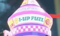 A holographic billboard of 1-Up Fuel in Mario Kart World