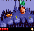 Dixie Kong runs near a Ghost Barrel in the level Ghoulish Grotto.