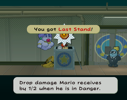 Mario getting the Last Stand badge from an open crate in Glitz Pit of Paper Mario: The Thousand-Year Door.