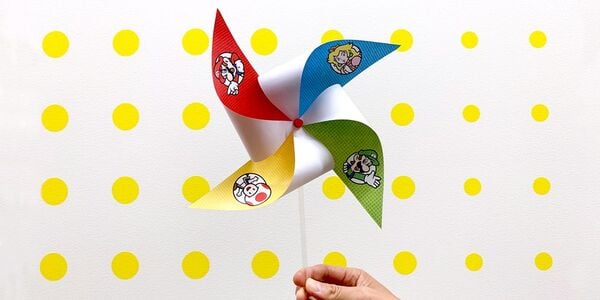 Photograph of a pinwheel featuring Mario, Luigi, Princess Peach, and Toad