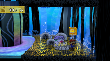 Mario next to the Shine Sprite in the bubble room in the Great Tree in the remake of the Paper Mario: The Thousand-Year Door for the Nintendo Switch.