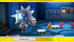 Mario being given the Puzzle Solver by the Battle Lab Toad in Toad Town of The Origami King.