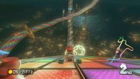 Mario going down the large ramp at the start of Mario Kart 8s version of <small>N64</small> Rainbow Road
