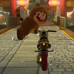 Tanooki Mario performs a trick.