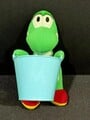 A plushie of Yoshi with a bucket from Mario & Wario