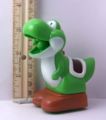 Plastic toy of a Yoshi with a retractable melon in its mouth