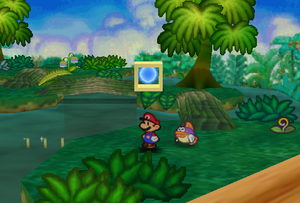 Mario standing next to the Super Block in Jade Jungle in Paper Mario.