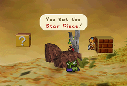Mario finding a Star Piece behind a rock in Gusty Gulch in Paper Mario
