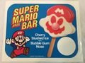 Promotional Super Mario Bros.-themed cherry ice cream bar, made by Gold Bond Ice Cream, Inc. The ice cream itself is in the shape of Mario's face with a bubble gum nose.