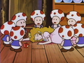 The Toads surrounding an unconscious Peach
