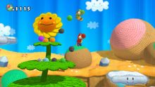 The Yoshis and a flower in Yoshi's Woolly World.