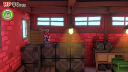 Mario standing near a crate containing a Mushroom in Toad Town of The Origami King.