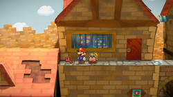 Mario finding a House Key in front of the badge shop in Paper Mario: The Thousand-Year Door for Nintendo Switch.