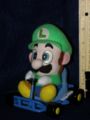 A plushie of Luigi from Super Mario Kart