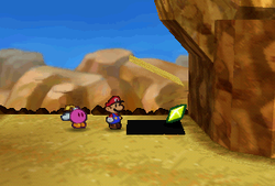 Mario finding a Star Piece under a hidden panel down the cliff in Mt. Rugged in Paper Mario