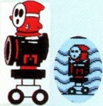 Artwork of Autobomb with Shy Guy. The sprite scan shows them in an area they do not appear in the final game. Additionally, the "M" on it is smaller and red instead of white, which carried over to subsequent artwork.