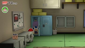 A group of staff Toads in the staff room of Shogun Studios. One Toad is folded on a desk near the entrance, another is rolled in a trash can, the third is stuck in the mouth of the Goomba Mask, and the Shuriken Dojo owner is resting in a locker.