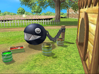 A close-up of the Chain Chomp in At the Chomp Wash in Mario Party 8. Behind the fence is a visible black void.