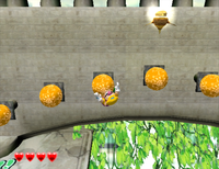 Wario climbing across Glue Globes in Greenhorn Ruins from Wario World.