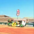 A Yoshi's food truck in Salty Salty Speedway with a variation of the red logo with a green background
