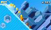 Mario. wearing a Gold Block, sliding down an icy hill towards some Goombas in World 4-3.