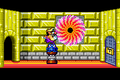 Wario hitting a switch in the Golden Passage in Wario Land 4